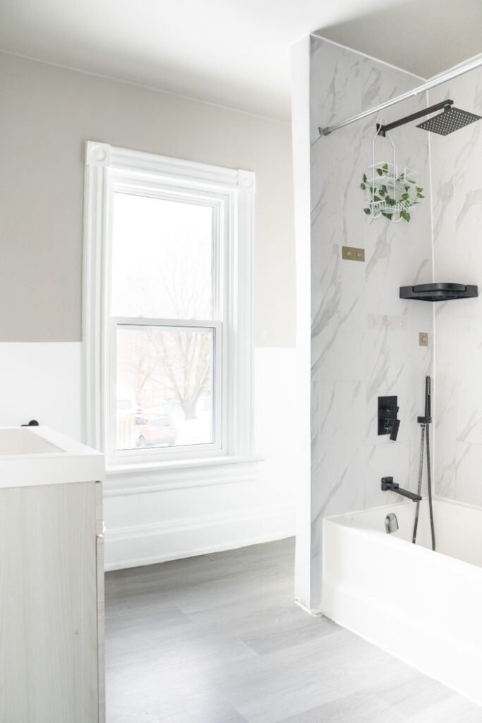 Bright minimalist bathroom featuring a marble shower and sleek fixtures.