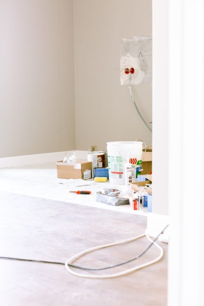Crafting Captivating Headlines: Your awesome post title goes here A room corner with renovation supplies, paint cans, and tools, ready for a home improvement project.